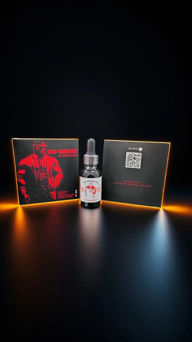 Black glass dropper bottle with silver cap and white label featuring a red graphic, positioned between two black boxes illuminated by orange backlighting.