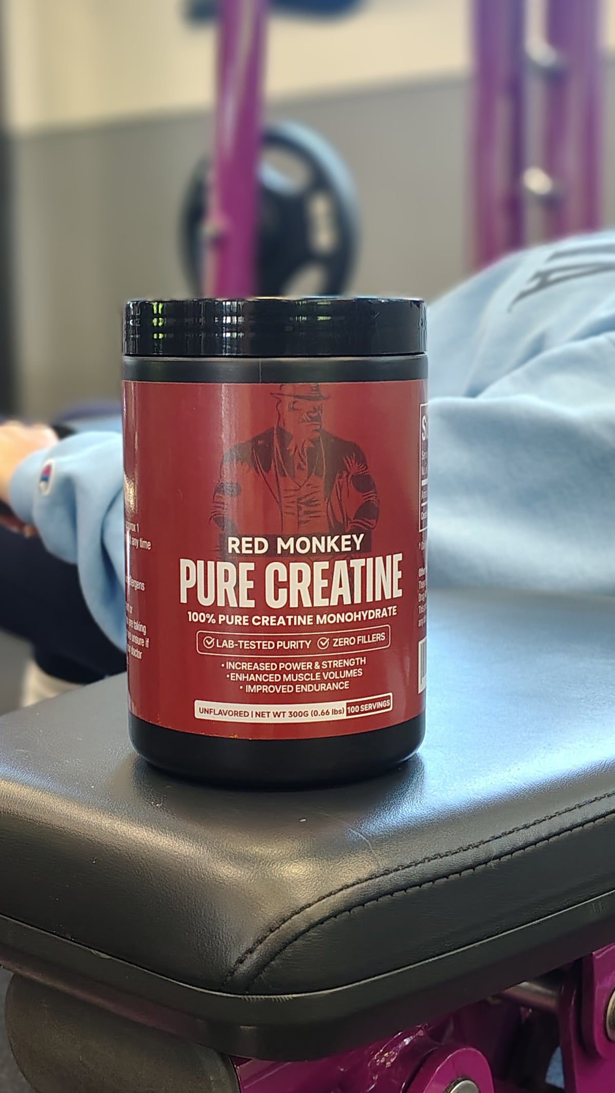 Red Monkey Pure Creatine Monohydrate tub on a gym bench, 300g, 100 servings